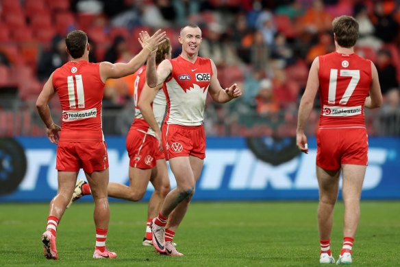 Chad Warner of the Swans celebrates with team mates