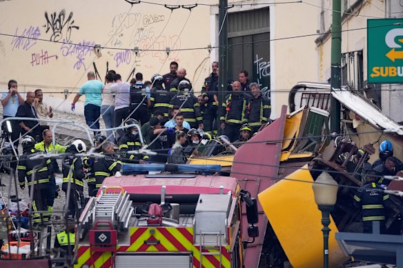 Emergency teams work at the site of a derailed electric streetcar in Lisbon on Wednesday.