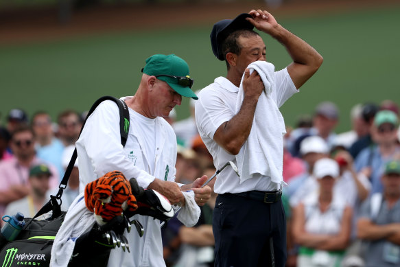 Tiger Woods wipes his face during the opening round.