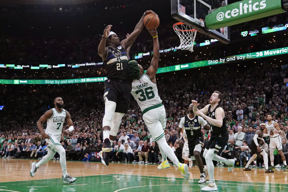 Jrue Holiday blocks a shot by Marcus Smart.