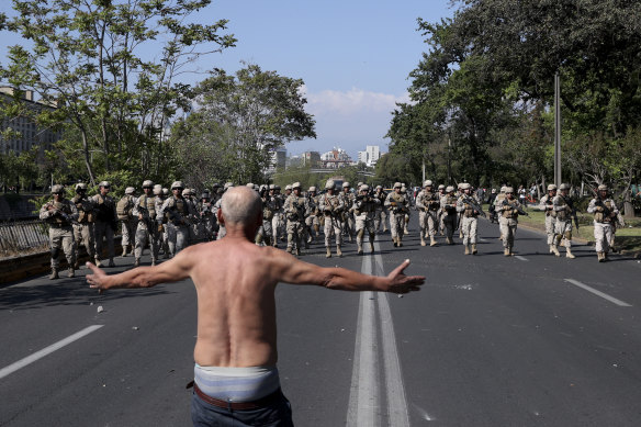 A man challenges soldiers during clashes in Santiago, Chile.