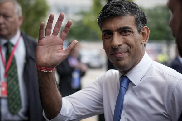 British Prime Minister Rishi Sunak walks to his hotel on the first day of the Conservative Party conference in Manchester.