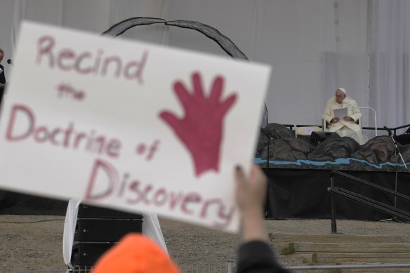 People protest as Pope Francis meets young people and elders at Nakasuk Elementary School Square in Iqaluit, Canada, last year.