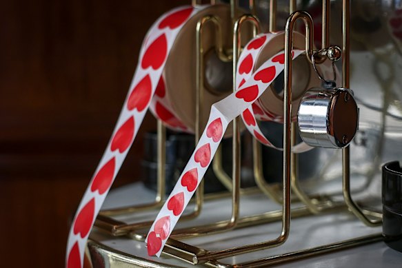 Red heart stickers are placed on patrons’ phone cameras at Le Splendide. 