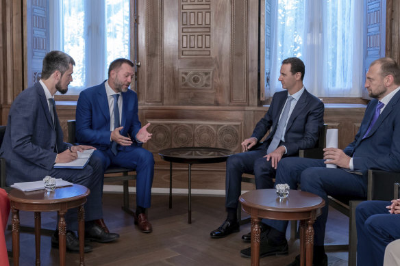 Russian-backed Syrian President Bashar al-Assad, second right, meets with Russian comrades in Damascus in August.  