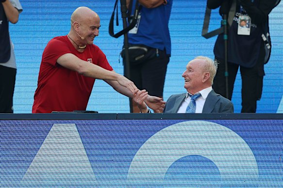 Agassi mostra respeito a Rod LAver na quadra.