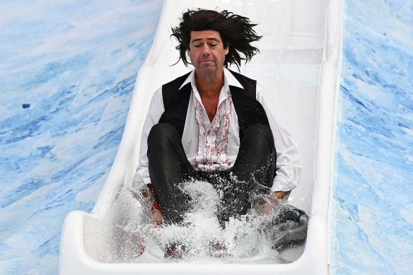 Dressed as Meat Loaf, AFL chief executive Gillon McLachlan slides into the ice bath. 