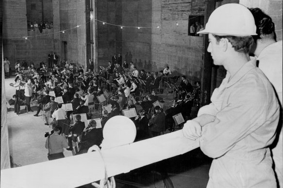 Opera House worker Paul Gianikouris listens to a performance by the London Symphony Orchestra at the Opera House site on March 26, 1966.