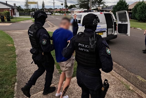 Heavily armed tactical police arrest Benedix Faner-Villegas at a home in Colyton on Tuesday