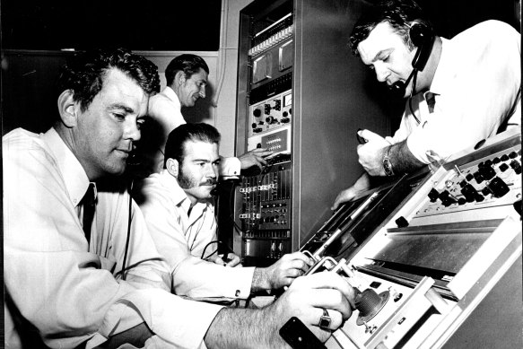From left, technicians Peter O’Donoghue and Laurie Routledge, Mr Peter Frost, (rear) and Ed Mason, the American N.A.S.A. project liaison officer, listening to the astronauts’ messages.