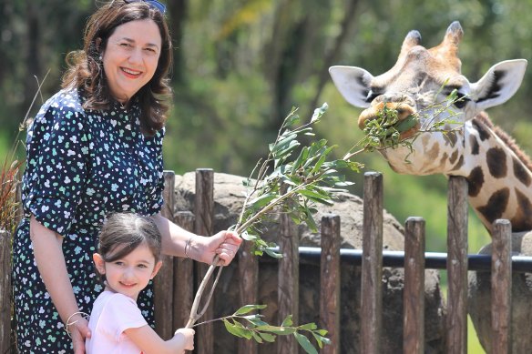 Premier Annastacia Palaszczuk, with her four-year-old niece Emma feeding a giraffe at Australia Zoo on Saturday.