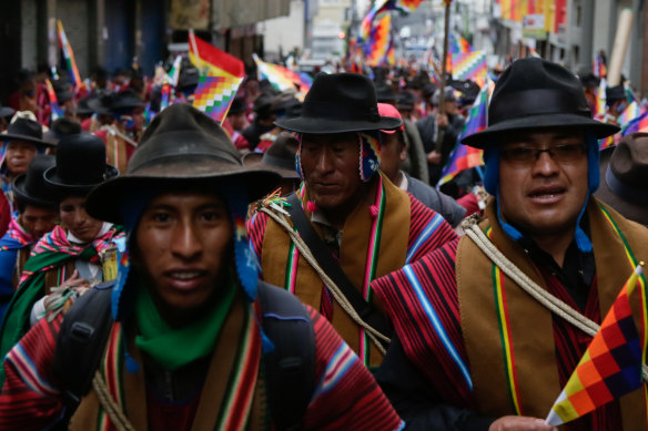 Supporters of ousted president Evo Morales take to the streets wearing traditional ponchos and waving Wiphala flags, a symbol used by the area's indigenous peoples.