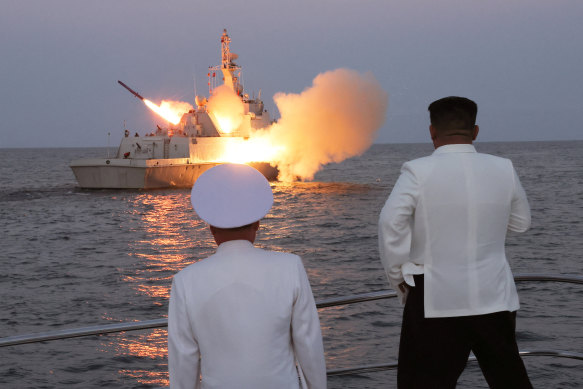 North Korean leader Kim Jong Un oversees a strategic cruise missile test aboard a navy warship.