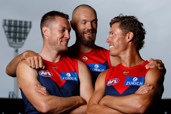 Jake Melksham (right) poses with Tom McDonald (left) and Max Gawn (centre). Melksham plays his 250th game against Essendon on Saturday.