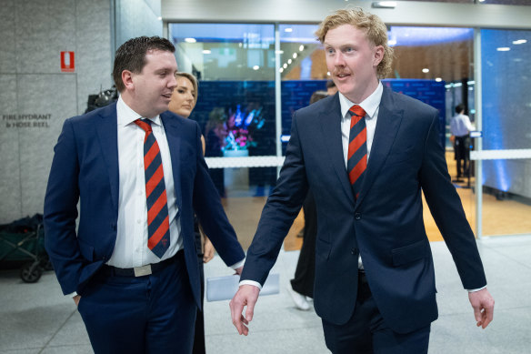 Clayton Oliver (pictured here with a Melbourne official) attended Friday night’s best-and-fairest function.