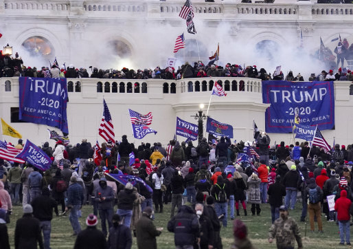 Supporters of President Donald Trump storm the Capitol on January 6. Bob Woodward and Robert Costa say Trump wallowed in denial of his election loss. 