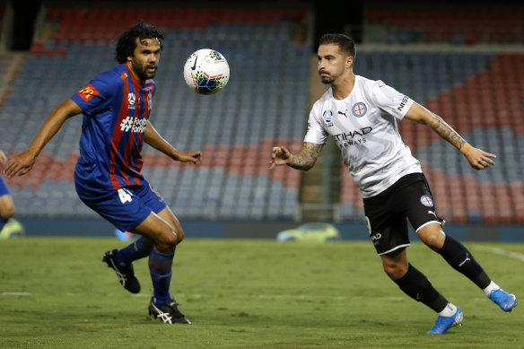 Newcastle's Nikolai Topor-Stanley and Melbourne City's Jamie Maclaren contest the ball in the last A-League match before the COVID-19 shutdown.