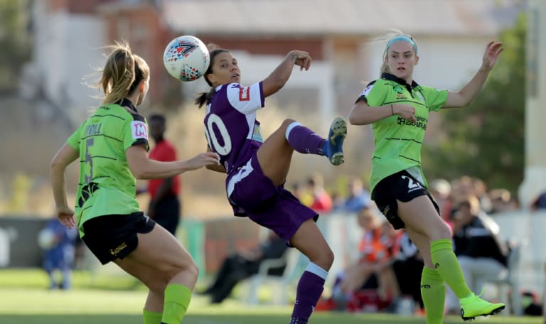 Perth star Samantha Kerr cuts between Canberra's Nikola Orgill and Ellie Carpenter. 