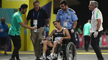 Andrey Petrov of Uzbekistan is taken away in a wheelchair after the men's marathon at Doha.