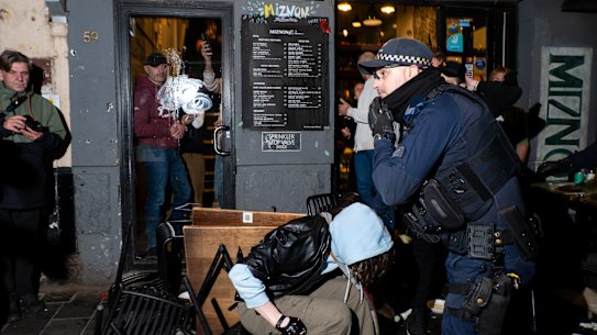 Four people have been arrested after a group descended on an Israeli restaurant in Melbourne on Friday.