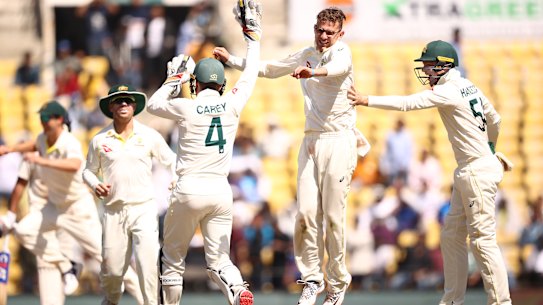 Todd Murphy celebrates taking the wicket of Virat Kohli on the way to a five-wicket haul.