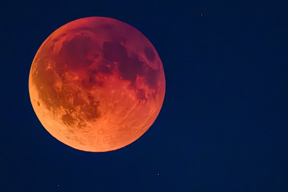 The moon appears red in a total lunar eclipse, known as the blood moon.
