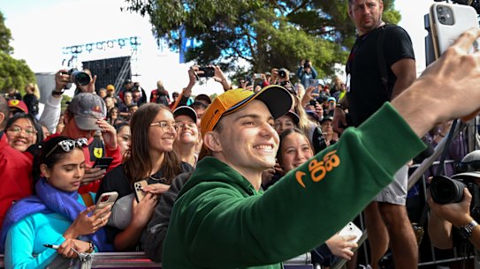 Oscar Piastri takes selfies with fans at Albert Park on Thursday.