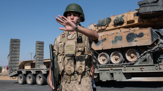 Offensive rolls on. Turkish military vehicles carry tanks to the Syrian border  at the weekend.