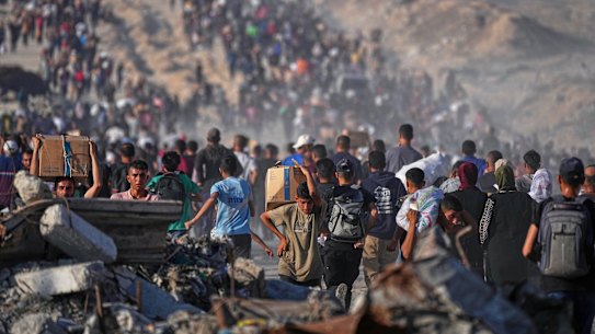 Palestinians carry sacks and boxes of food and humanitarian aid in northern Gaza this week.