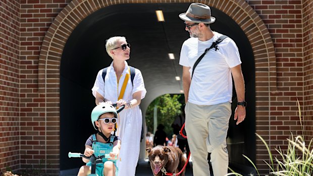 Alexandra and Wesley Nel walk along the completed Greenway with their son and dog on Sunday.