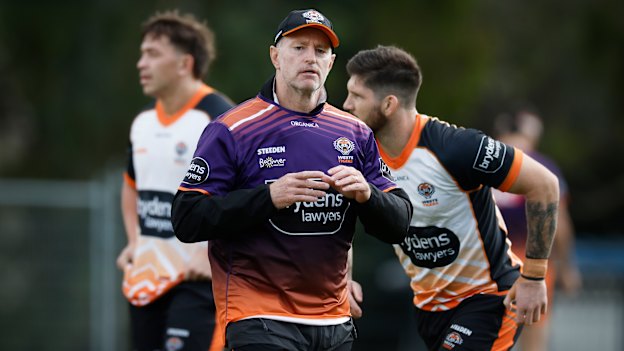 Wests Tigers coach Michael Maguire runs his eye over the team at training.