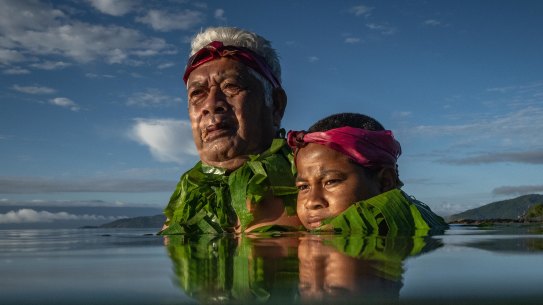 Kioa island resident Lotomau Fiafia and his grandson John stand roughly where the shore line used to be when Lotomau was a child in the 1950s, he has seen the changes of the shore line in the past decade.