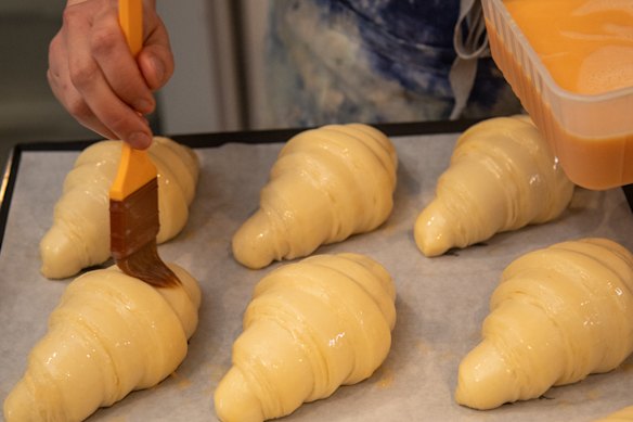 Eggwash goes on before baking.
