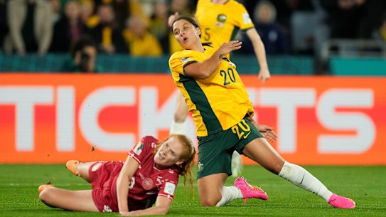 Sam Kerr challenges with Denmark’s Stine Ballisager.