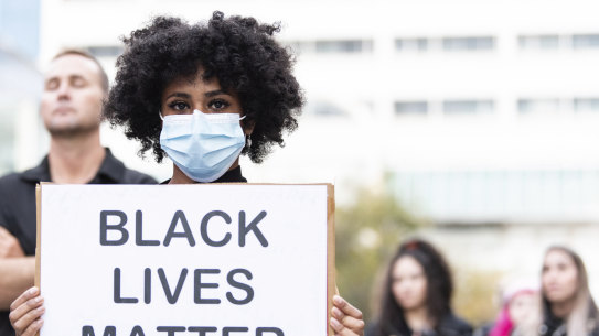 People wore facemasks and tried to adhere to social distancing measures as they protested in Forrest Chase. 