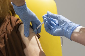 A volunteer receives a jab of the AstraZeneca vaccine.