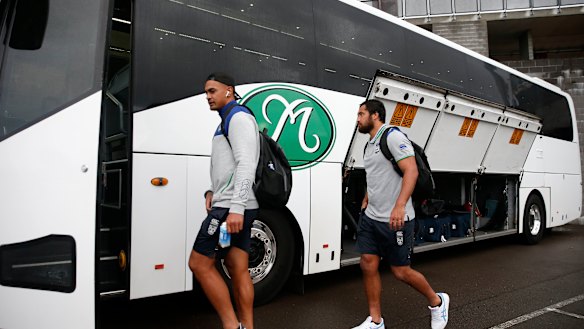 Warriors players board the team bus after the round-one match against the Knights. The New Zealand side will now stay in Australia.