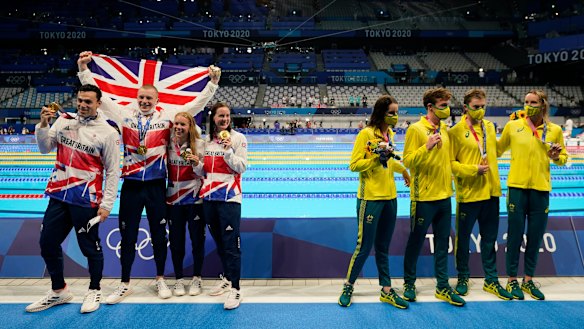 Britain (Kathleen Dawson, Adam Peaty, James Guy and Anna Hopkin) pose after winning gold. Australia (Kaylee McKeown, Zac Stubblety-Cook, Matthew Temple and Emma McKeon), right, won bronze.