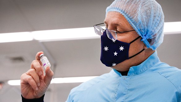 Prime Minister Scott Morrison with a vial of the Oxford-AstraZeneca vaccine in February. 