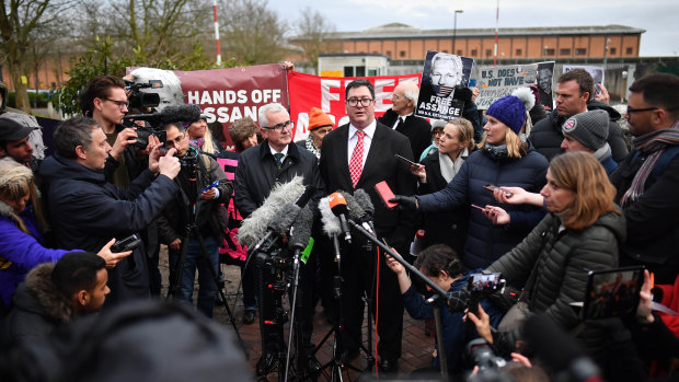 Andrew Wilkie and George Christensen surrounded by international media outside the prison.