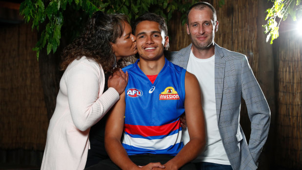 Jamarra Ugle-Hagan poses for a photograph with parents Alice and Aaron.