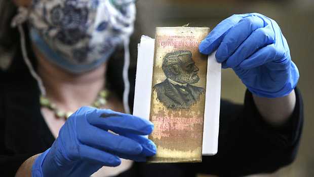 Not Lincoln: Gretchen Guidess holds up a ribbon with the likeness of Robert E. Lee, one of the artefacts inside the copper box time capsule.