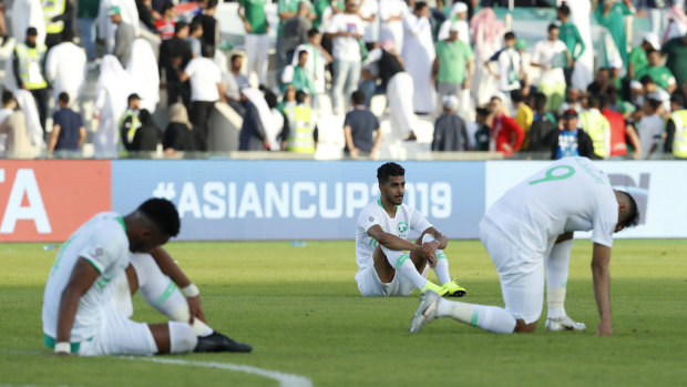 The Saudi players react after the final whistle.