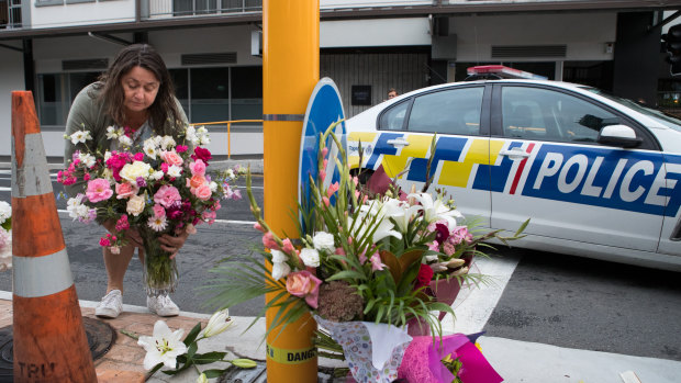 Locals gather to lay flowers near Masjid Al Noor Mosque in Christchurch after a terror attack by a gunman killed 49 people.