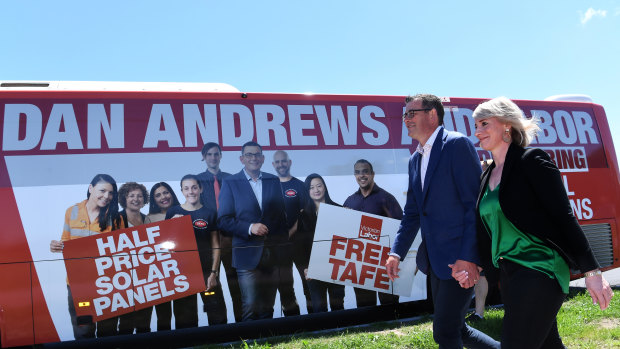 Victorian Premier Daniel Andrews (left) and his wife Catherine board the big red Labor bus. 
