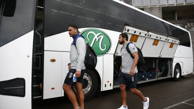 Warriors players board the team bus after the round-one match against the Knights. The New Zealand side will now stay in Australia.