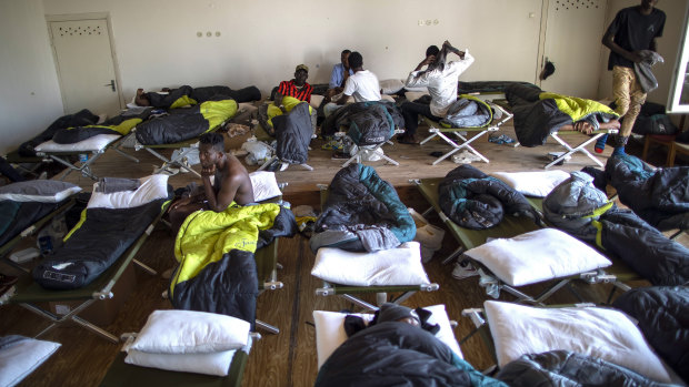 Migrants from Cameroon rest at the refugee camp in the village of Vydeniai, Lithuania.