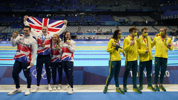 Britain (Kathleen Dawson, Adam Peaty, James Guy and Anna Hopkin) pose after winning gold. Australia (Kaylee McKeown, Zac Stubblety-Cook, Matthew Temple and Emma McKeon), right, won bronze.