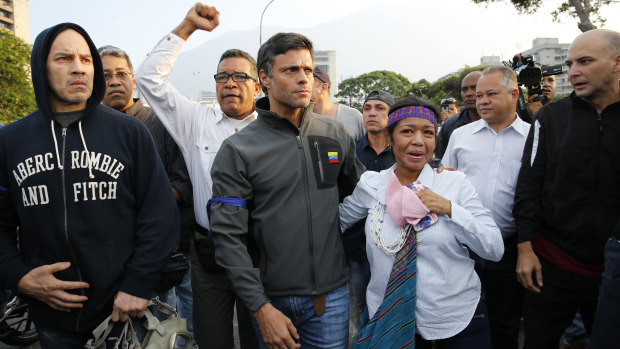 Leopoldo Lopez, centre, is seen surrounded by supporters outside La Carlota air base in Caracas.