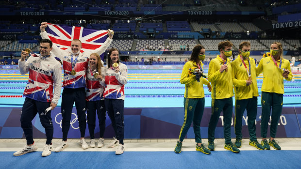Great Britain (Kathleen Dawson, Adam Peaty, James Guy and Anna Hopkin) pose after winning gold in the mixed 4x100 medley relay. Australia (Kaylee McKeown, Zac Stubblety-Cook, Matthew Temple and Emma McKeon), right, won bronze.